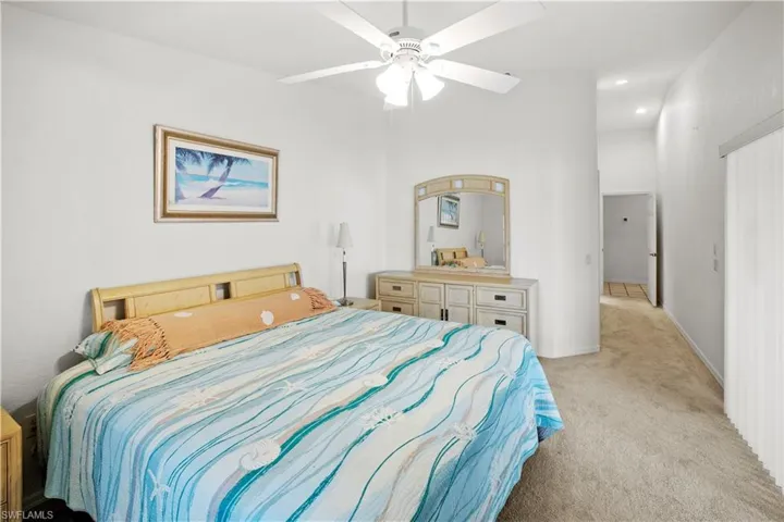 spacious 12 x 16 primary bedroom and gorgeous lake views and sliders out to the relaxing lanai