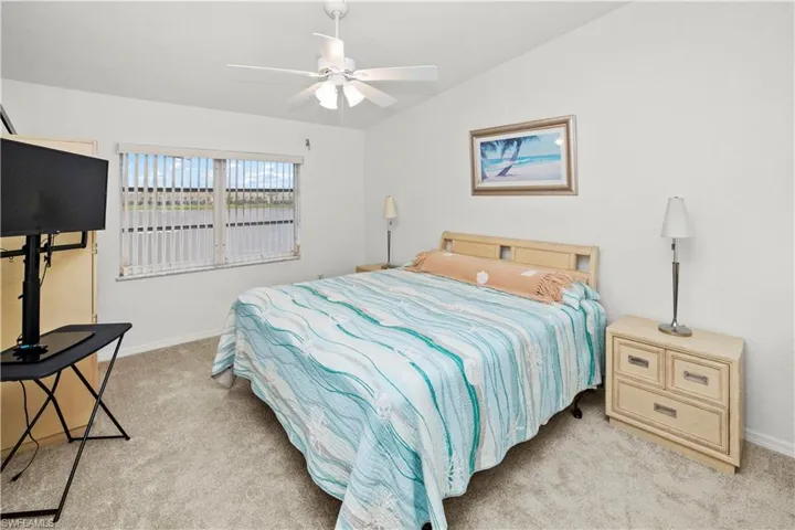 spacious 12 x 16 primary bedroom and gorgeous lake views and sliders out to the relaxing lanai