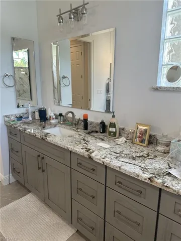 Bathroom featuring tile patterned floors and vanity