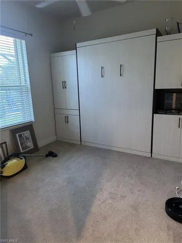 Unfurnished bedroom with light colored carpet