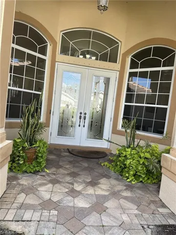 View of exterior entry featuring french doors