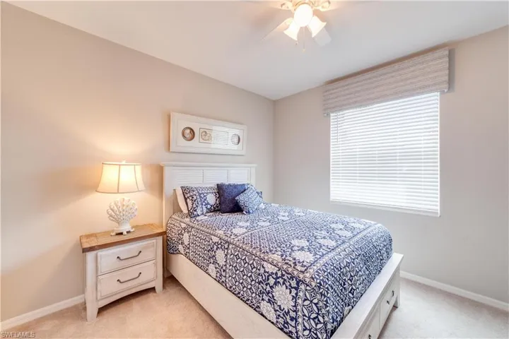 Third Bedroom with baseboards, a ceiling fan, and light colored carpet