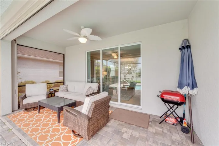 View of patio / terrace with great views of the lake, completely covered outdoor lounge area, electric storm screens and a ceiling fan