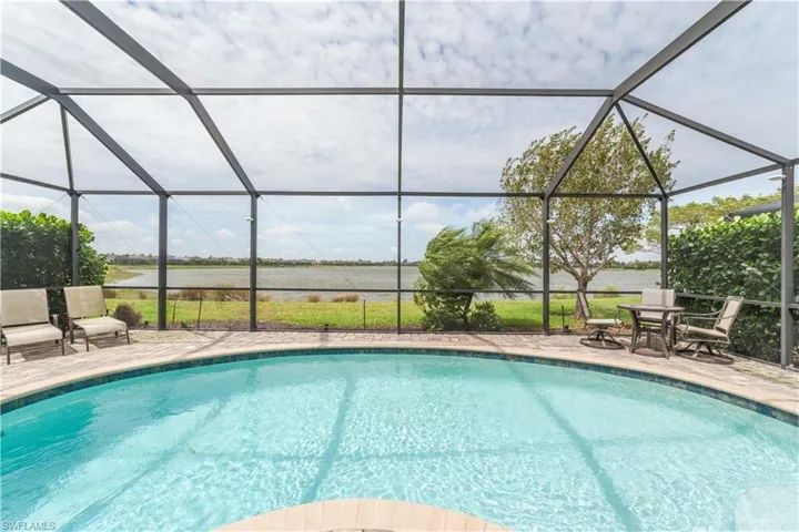 Wonderful lake views! Outdoor pool with a patio and a lanai