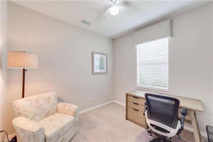 Forth Bedroom being used as a Home office with light carpet, baseboards, closet and ceiling fan