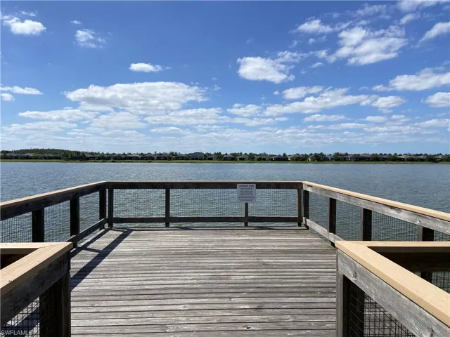 View of community fishing pier  featuring a water view