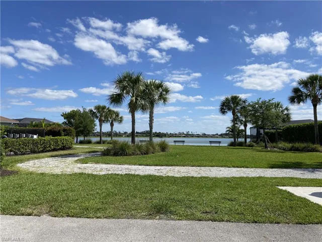 View of home's community area with benches and with a water view