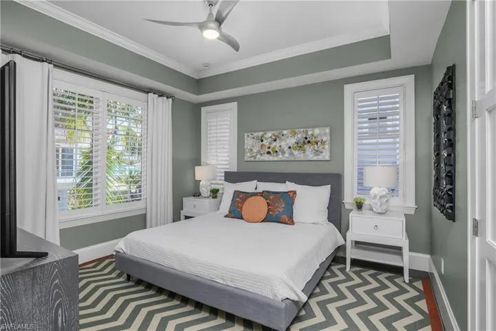 Bedroom with crown molding and ceiling fan