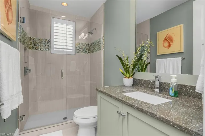 Bathroom with vanity and a stall shower