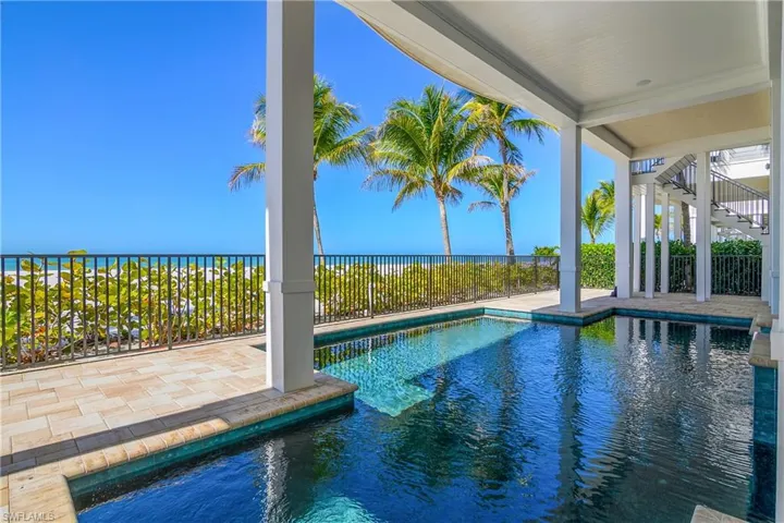 View of pool featuring patio surround and a water view