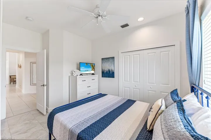 Full bathroom with vanity, a shower stall, tile patterned flooring, and recessed lighting