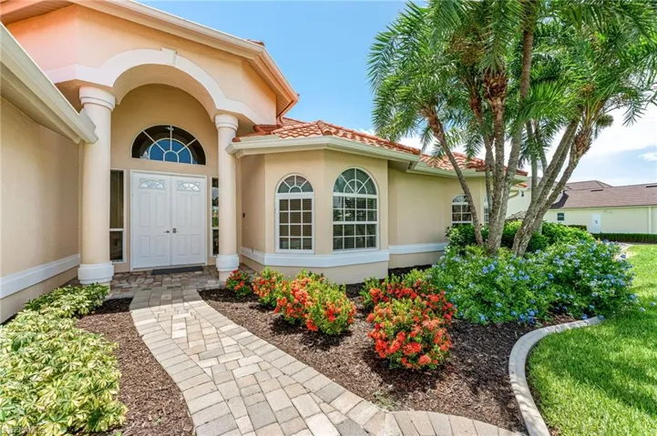 Mediterranean / spanish home with stucco siding, an attached garage, and a front yard