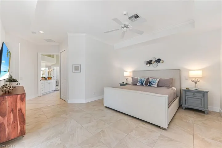 Full bathroom featuring vanity, a ceiling fan, a bath, tile patterned flooring, and vaulted ceiling