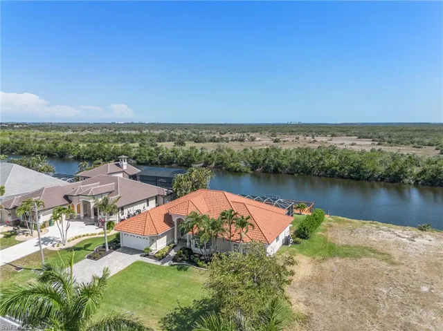 Aerial view of property and surrounding area with a large body of water