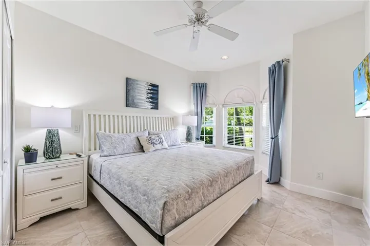 Bedroom featuring light tile patterned floors, connected bathroom, ceiling fan, and recessed lighting