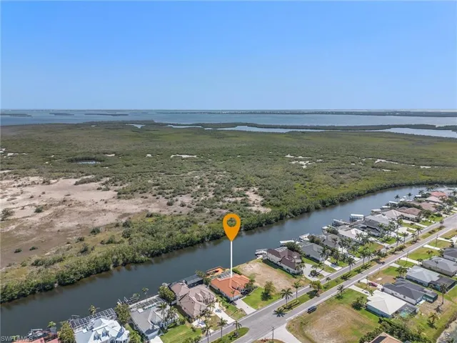Aerial overview of property's location featuring a large body of water and nearby suburban area