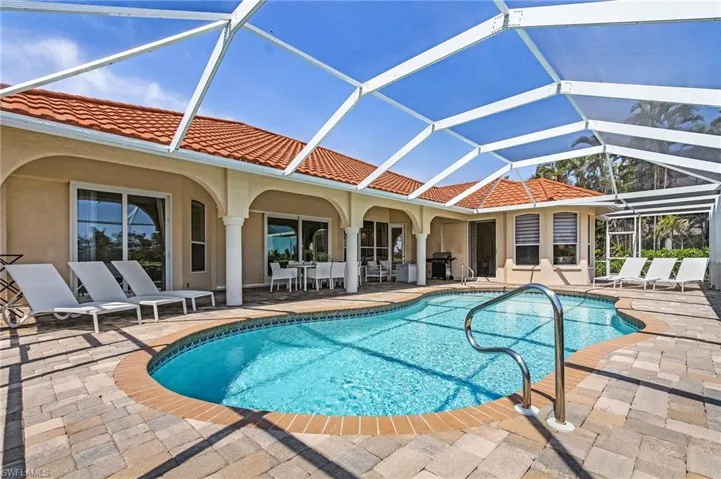 Outdoor pool with a patio area, a lanai, and a grill
