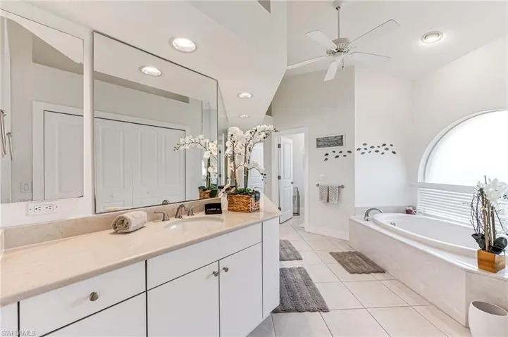 Full bathroom with tiled shower and tile patterned flooring