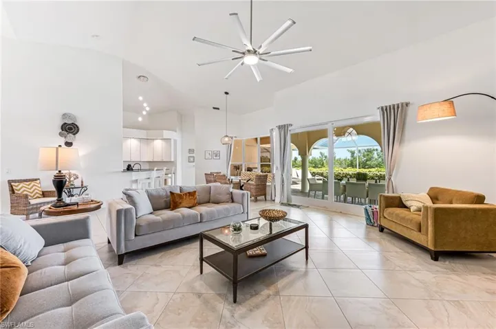 Dining area with light tile patterned floors and a towering ceiling