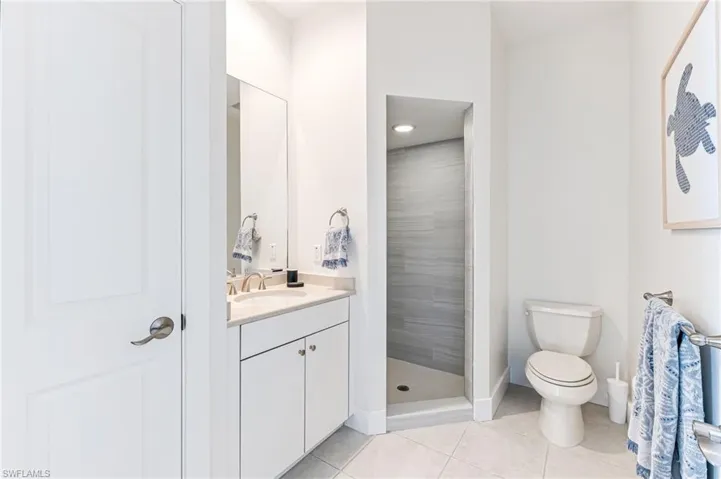 Bedroom with light marble finish flooring, ceiling fan, and recessed lighting
