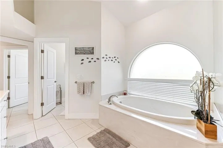 Full bathroom featuring vanity, a bath, tile patterned flooring, a ceiling fan, and recessed lighting