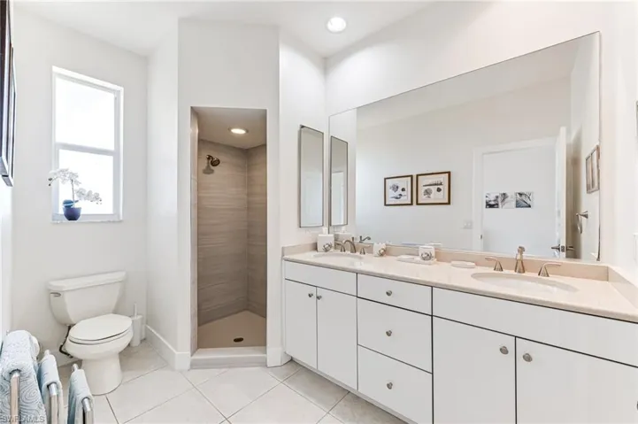 Bedroom featuring light marble finish floors, a closet, ceiling fan, and recessed lighting