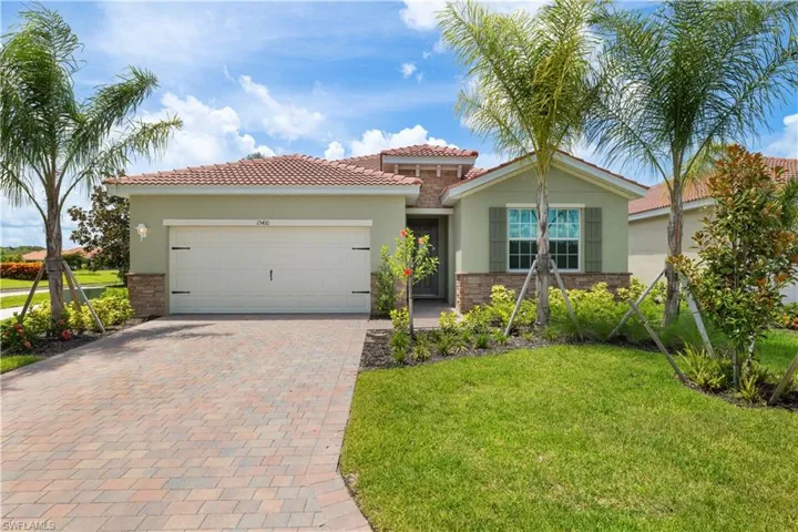 View of front of property with a garage and a front yard