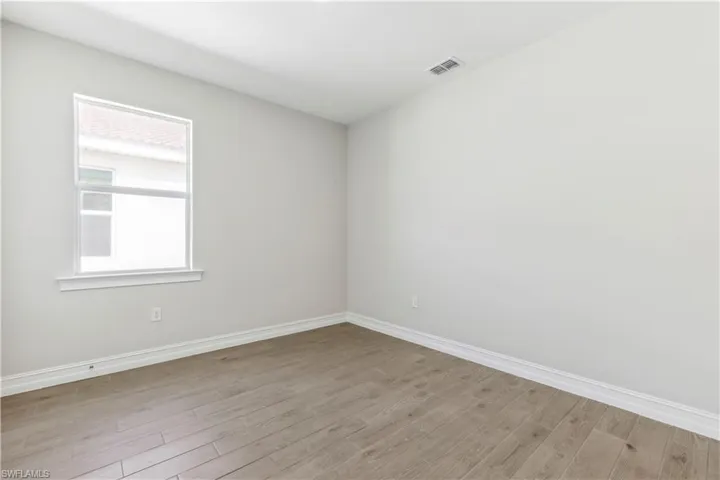 Unfurnished room featuring light wood-type flooring and plenty of natural light