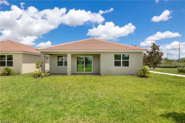 Rear view of property with a yard