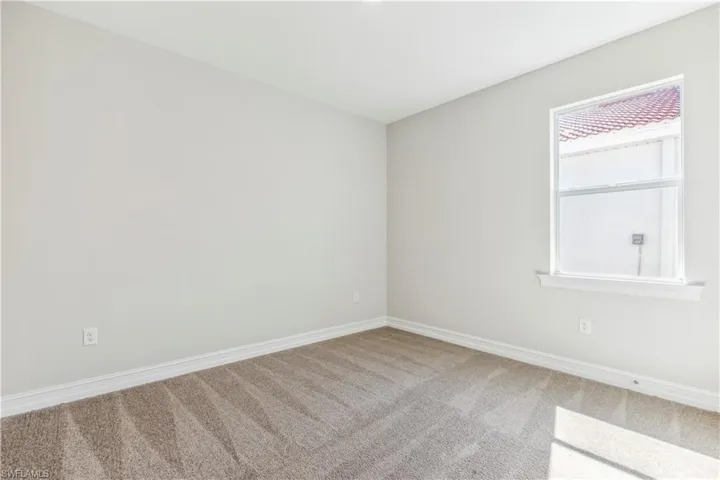 Spare room featuring carpet