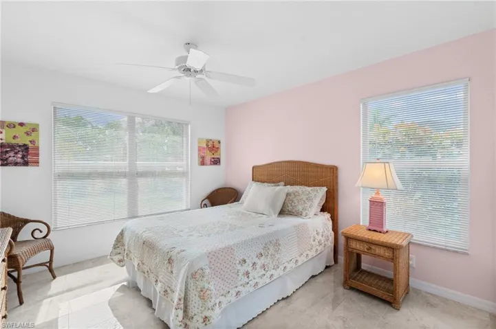 Bedroom with a ceiling fan and baseboards