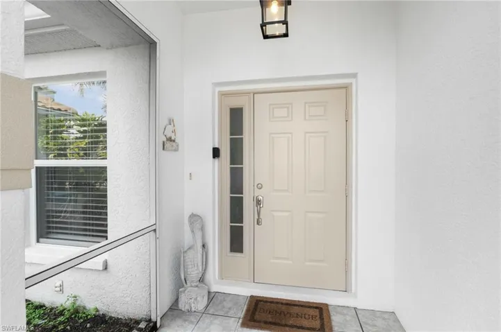 View of exterior entry featuring stucco siding