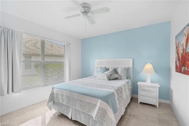 Bedroom with ceiling fan and baseboards