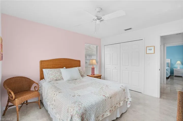 Bedroom with ceiling fan, a closet, and visible vents