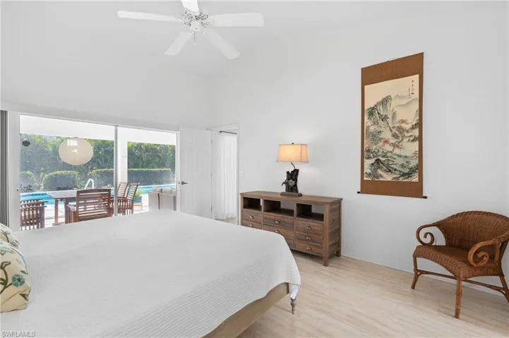 Bedroom with a ceiling fan, access to outside, and high vaulted ceiling