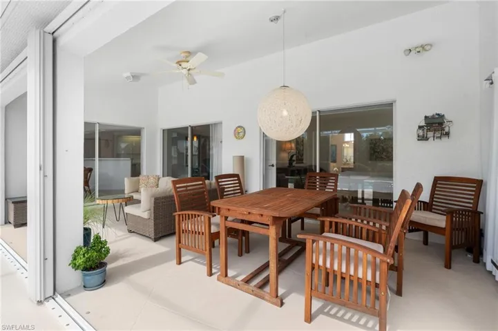 View of patio with outdoor dining space and a ceiling fan