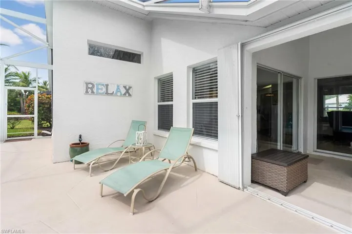 View of patio featuring glass enclosure