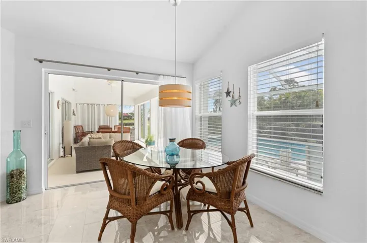 Dining area featuring lofted ceiling and baseboards