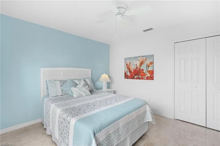 Bedroom with a ceiling fan, a closet, visible vents, and baseboards