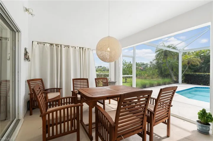 Dining space featuring a sunroom and vaulted ceiling