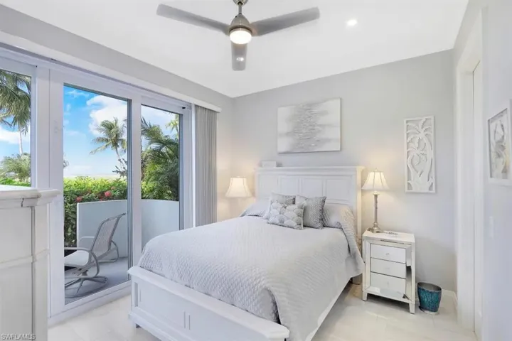 Bedroom featuring a ceiling fan, baseboards, and light tile patterned floors