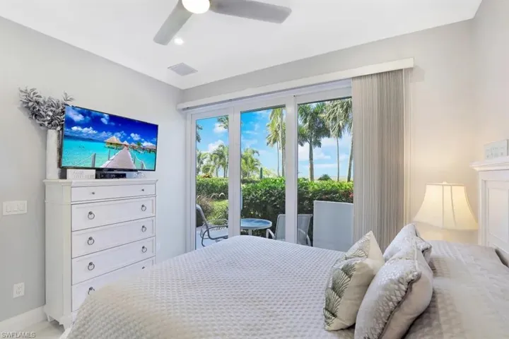 Bedroom with visible vents, a ceiling fan, baseboards, and access to exterior