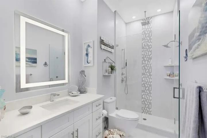 Full bath featuring a shower stall, toilet, vanity, and recessed lighting