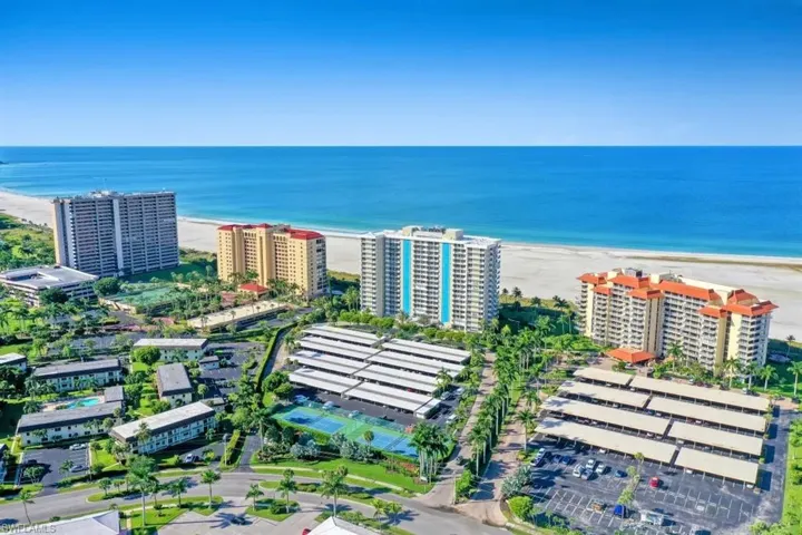 Drone / aerial view featuring a view of the beach and a water view