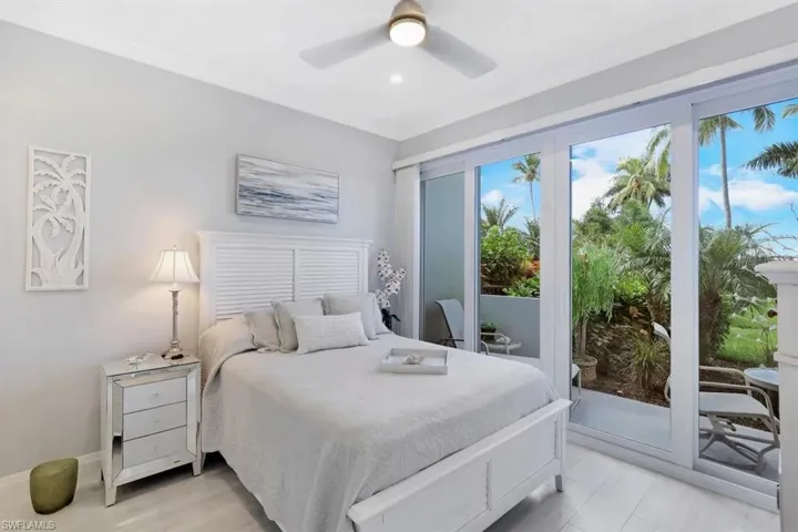 Bedroom with a ceiling fan, baseboards, and access to outside