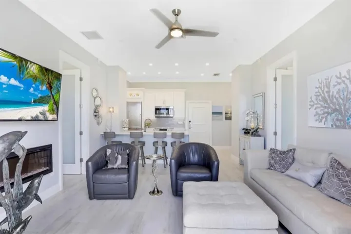 Living area with recessed lighting, visible vents, a ceiling fan, light wood-style floors, and baseboards
