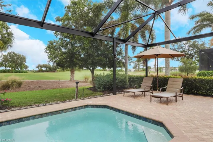 Swimming pool with a lanai, a sunroom, and a patio