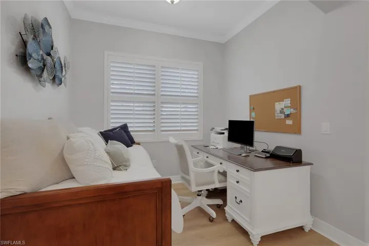 Office space featuring crown molding and light wood finished floors
