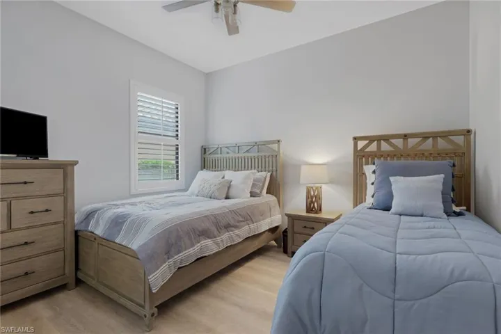 Bedroom featuring wood finished floors and ceiling fan