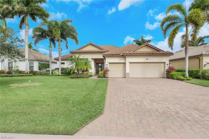 Mediterranean / spanish home featuring stucco siding, a front yard, an attached garage, decorative driveway, and a tile roof